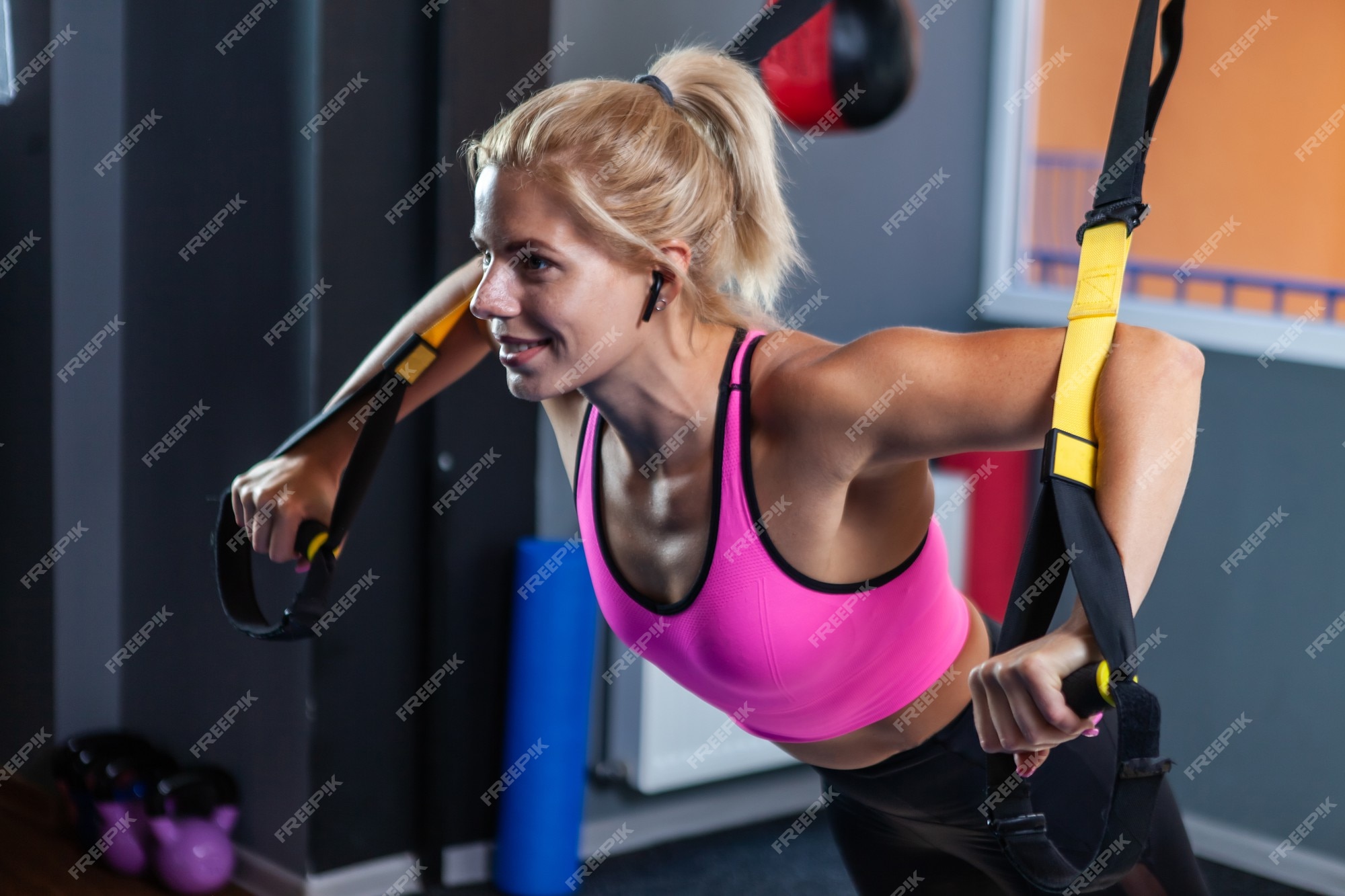 Premium Photo  Sporty women training with fitness trx straps in the gym.  suspension straps training.