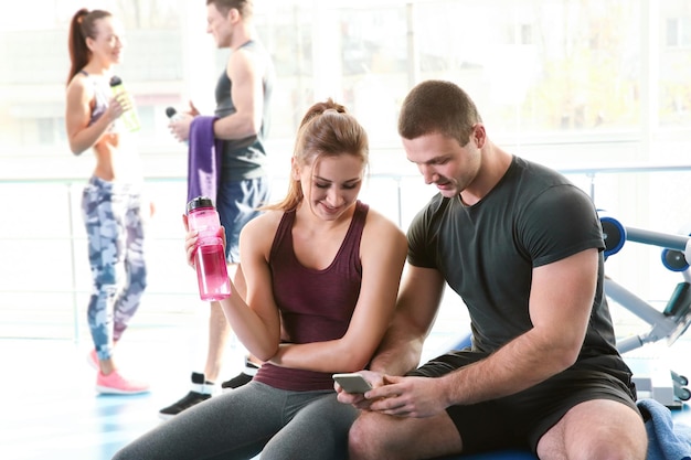 Sporty young couple in gym