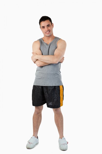 Sporty young male with arms folded