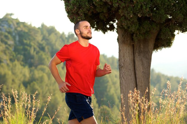 Sporty young man running outdoors