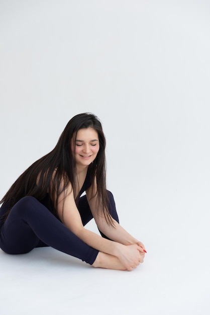 Sporty young woman doing relaxing yoga practice isolated on white background