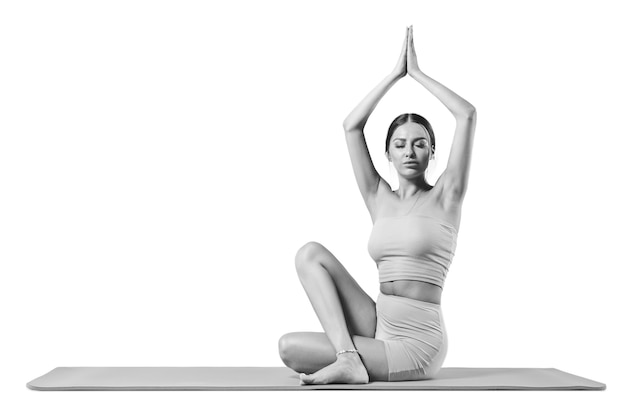 Sporty young woman doing yoga practice. Isolated on a white background. The concept of a healthy lifestyle and natural balance between body and mental development. Pilates, stretching.