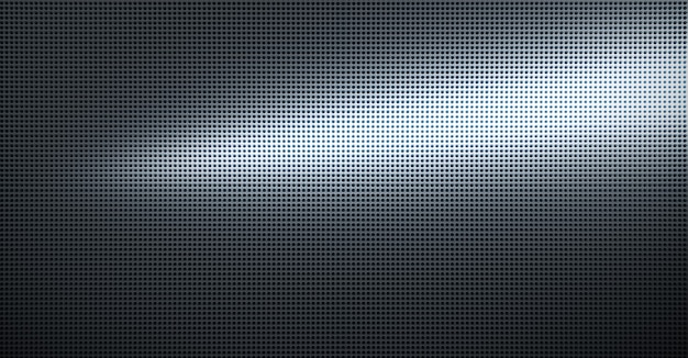 Spot lit perforated metal plate. Metal background close-up