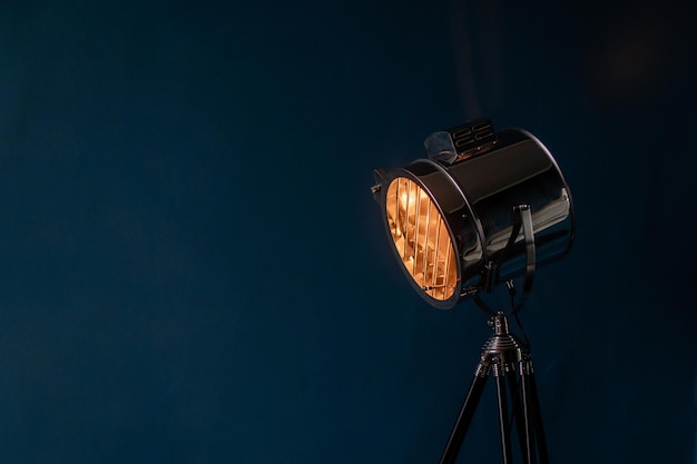 Spotlight lamp on blue wall background