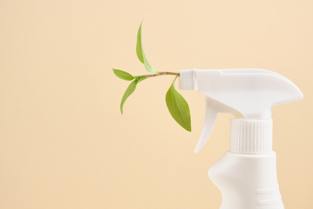 spray bottle with leaf spray for eco friendly natural cleaning concepts. on beige background copy space