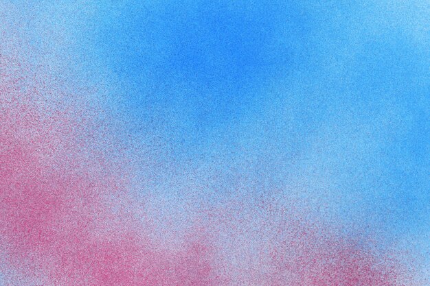 Spray paint red and blue on a white paper background