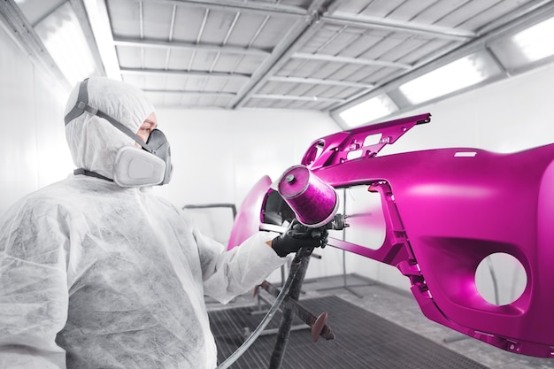Photo spraying the paint to the car element. paint coating business with ceramic coating. automobile industry.