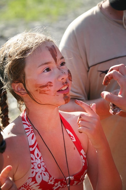 Spread chocolate on girl's face