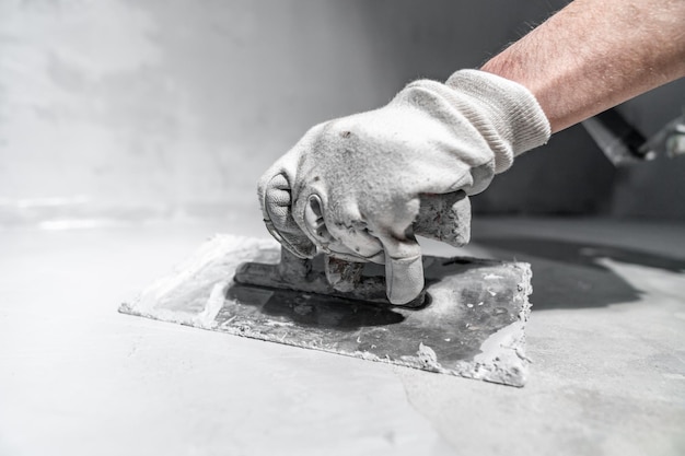 Spreading the insulation on the concrete with a trowel