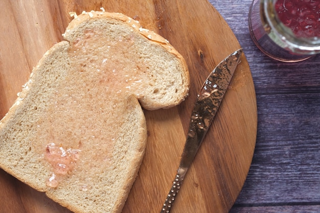 Spreading jam on on slice bread