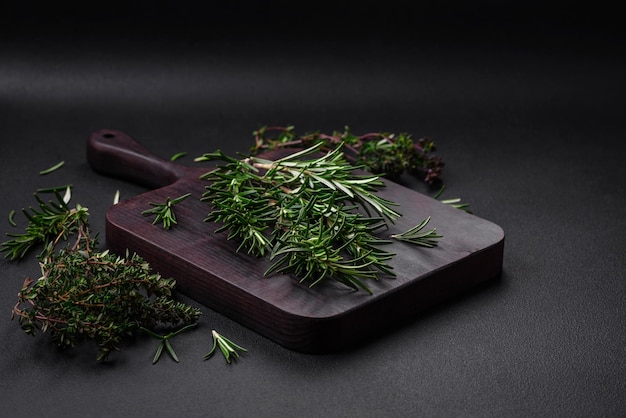 Sprigs of fresh green rosemary on a wooden cutting board