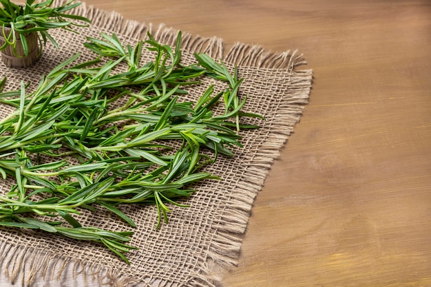 Sprigs of rosemary on burlap napkin