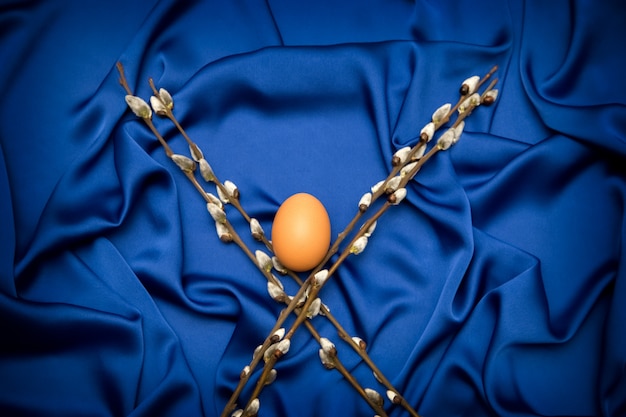 Sprigs of willow and egg on a blue