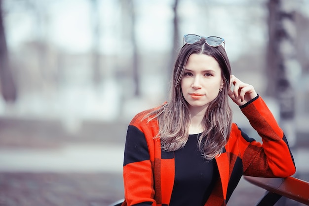 spring adult girl outdoor / March in Scotland, a girl in a plaid poses in the park