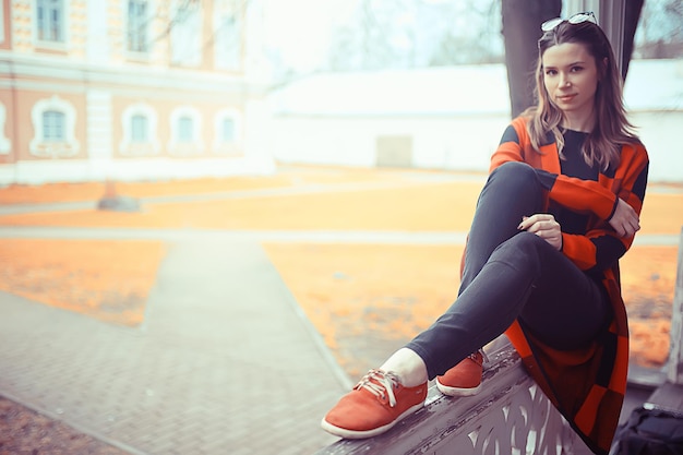 spring adult girl outdoor / March in Scotland, a girl in a plaid poses in the park