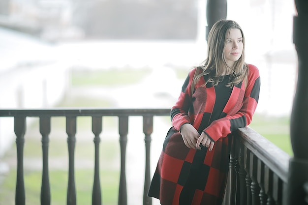 spring adult girl outdoor / March in Scotland, a girl in a plaid poses in the park