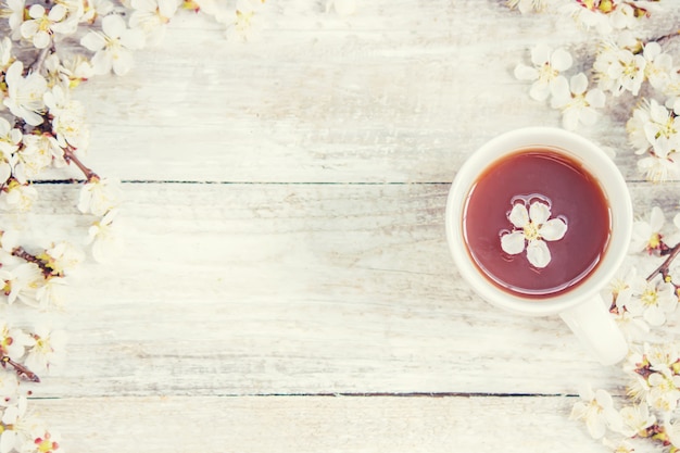 Spring background, flowers and tea. Selective focus.