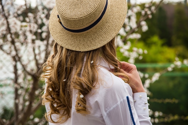 Spring beautiful life style blonde girl among flowers