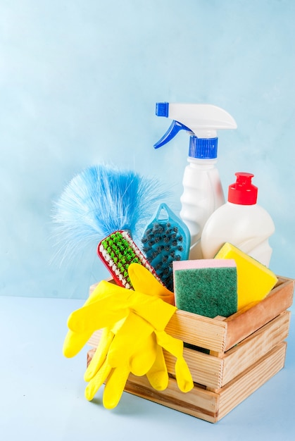 Spring cleaning concept with supplies, house cleaning products pile. Household chore concept, on light blue background copy space