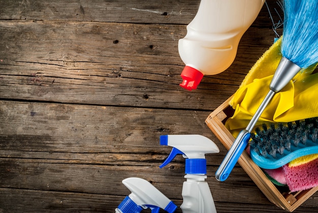 Photo spring cleaning concept with supplies, house cleaning products pile. household chore concept, on rustic or garden wooden background copy space  top view