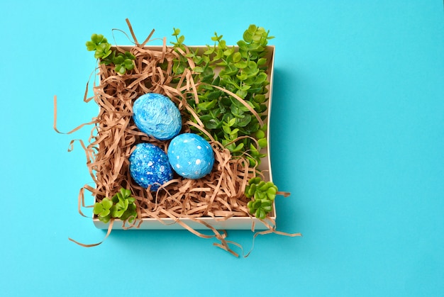 Spring Easter colorful painted eggs on the blue background