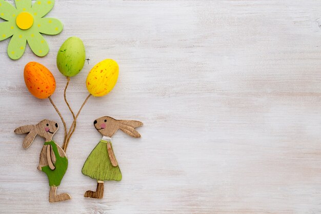 Spring and Easter decor with wooden symbols bunny, flowers and butterflies