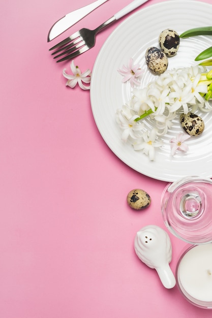 Spring Easter Table setting with hyacinth flowers on a pink background