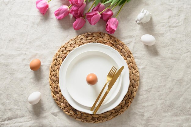 Spring Easter table setting with organic eggs pink tulips