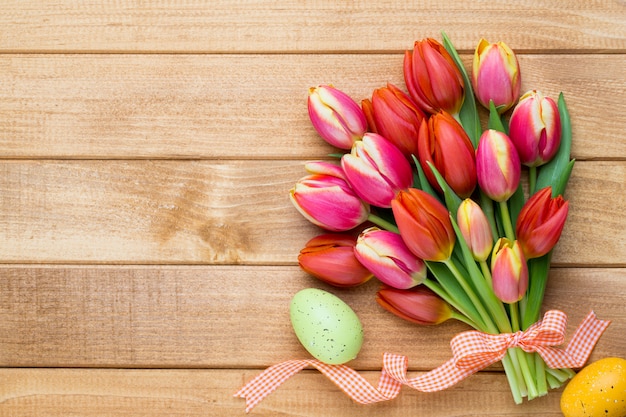 Spring easter tulips in bucket on wooden vintage.