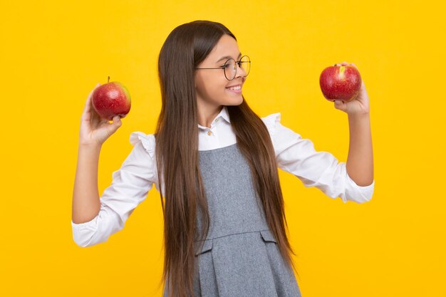 Spring everywhere spring season fruits full of vitamins organic food only natural and healthy happy childhood kid eat apple child with fruit Happy girl face positive and smiling emotions