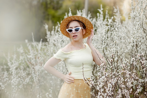 Spring fashion girl outdoor portrait in bloom . Beauty Romantic woman in flowers. Beautiful Woman Enjoying Nature.