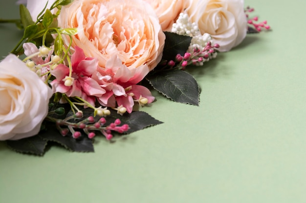 Spring feminine background, vintage flower composition on green board.