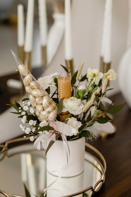 Spring floral arrangement with bees made of bee wax Sweet nuts in chocolate in a bouquet