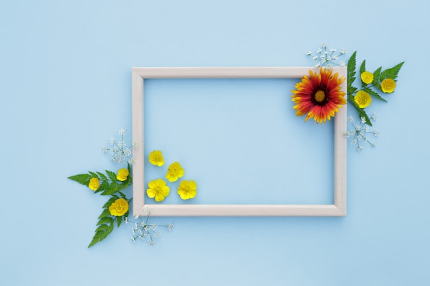 Spring, floral background. Flower arrangement. Frame with yellow-orange flowers on a light background.