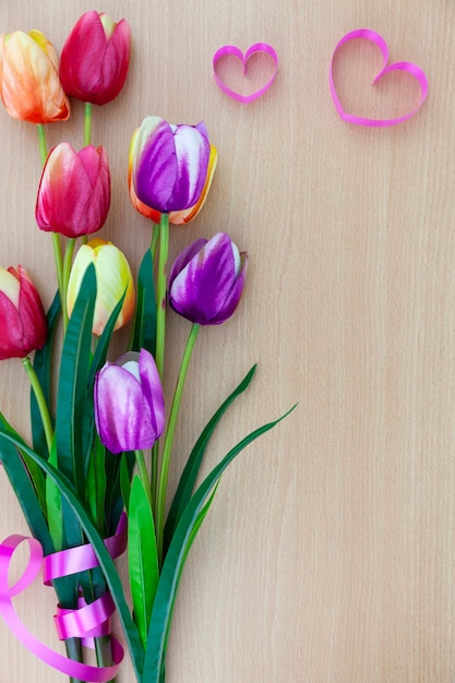 Spring flower of multi color Tulips on wooden