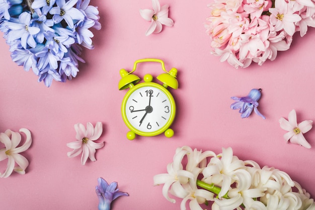 Spring flowers and alarm clock