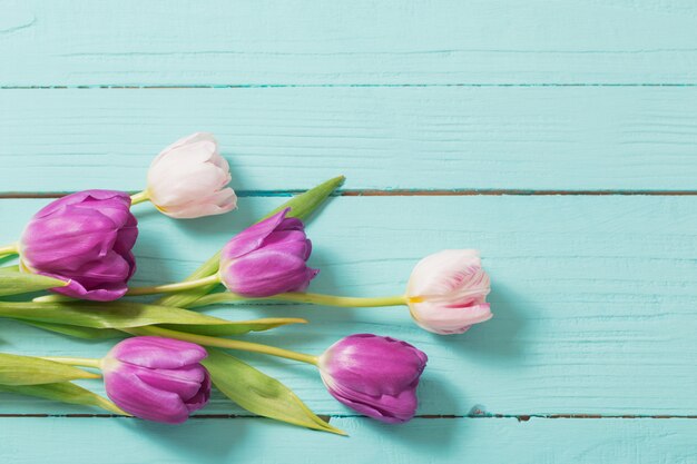 Spring flowers on blue mint wooden table