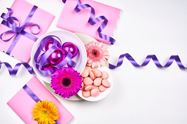 Spring flowers and sweets on white