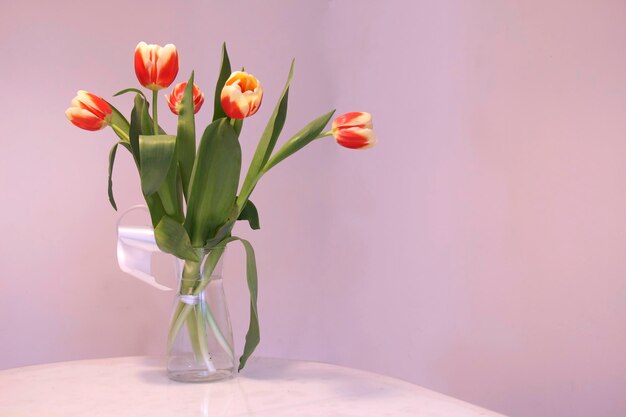 Spring flowers tulips on the table in a glass vase