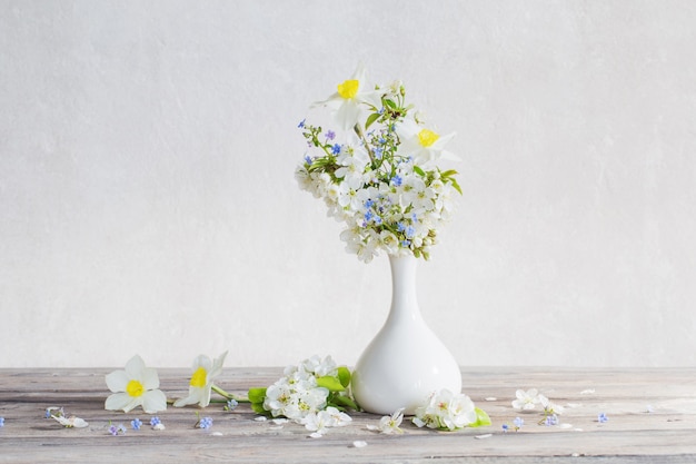 Spring flowers in vase on wooden table