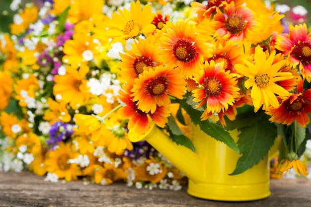 Spring flowers in watering can