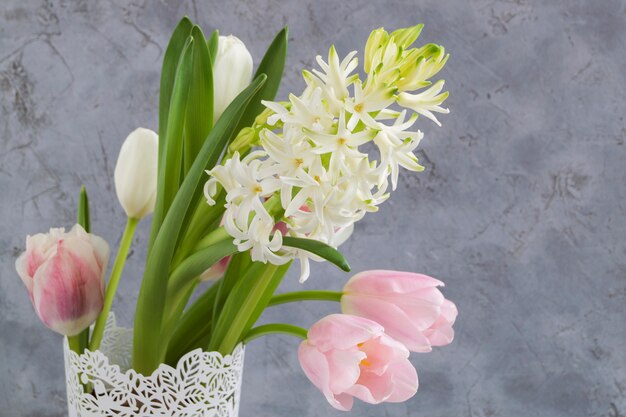 Spring flowers in a white vase.