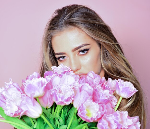 Spring girl with flowers. Portrait of a beautiful fashion woman. Face close-up.