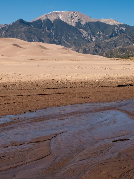 Spring at Great Sand Dunes National Park, Colorado. Medano Creek flows around the base of the dunes in springtime.