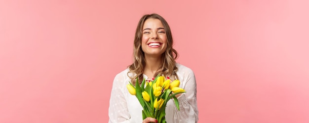 Spring happiness and celebration concept closeup of happy and carefree blond european girl receive b