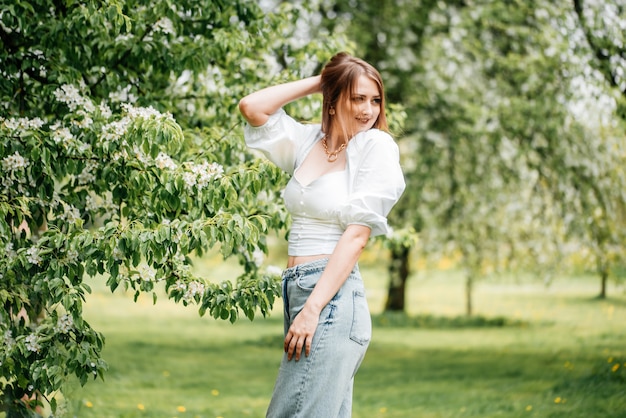 Spring is in the air. Nature ressurection after long sleep. Tender woman portrait in Japanese blooming emerald garden. Femininity of smiling happy cute girl with unusual lifestyle activity outdoors