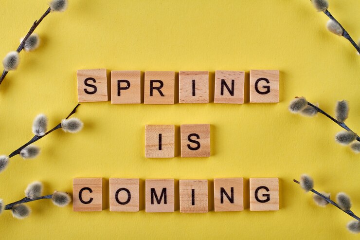 फोटो spring is coming wooden cubes. willow branches on yellow background.