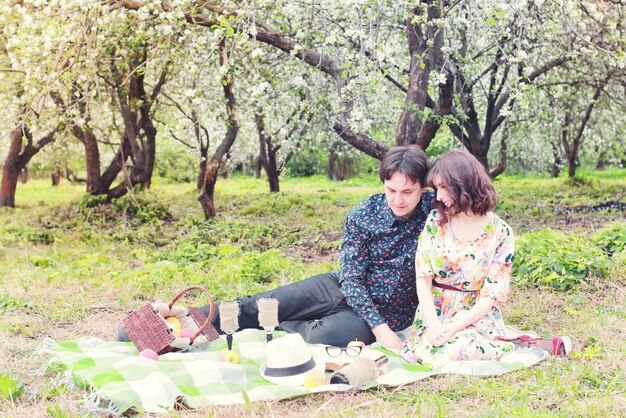 Spring landscape couple in love outdoor tree picnic