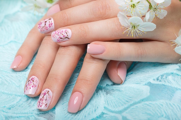 Spring manicure for the bride in gentle tones with flowers Nail Design Closeup