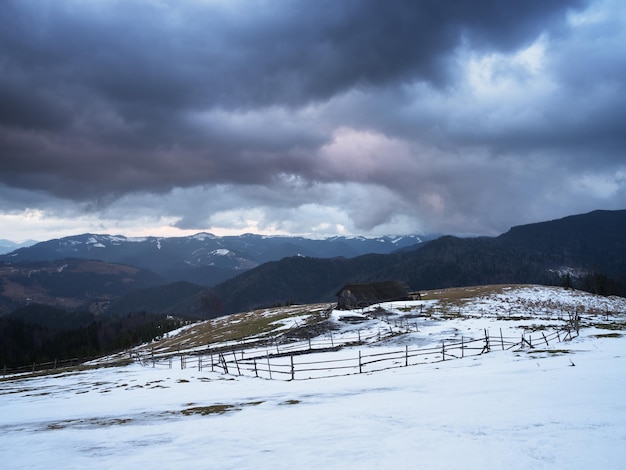 Spring in mountains Old wooden barn in a clearing Carpathians Ukraine Europe